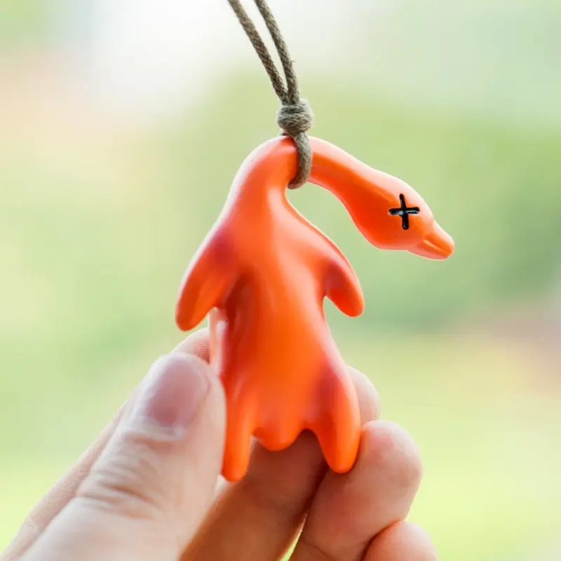 A duck car hanger and key hanger that changes color when exposed to light