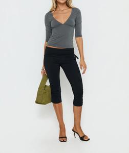 Black fold-over waist capri leggings,capri pants outfit, Y2K low-rise ruched side-tie bodycon pants, slim-fit stretchy cropped trousers, Y2K fashion, street style, going-out pants, low-rise pants, bodycon pants